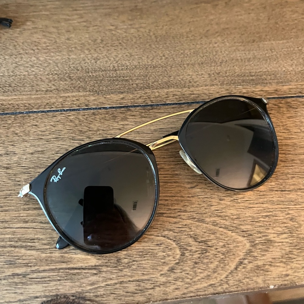 Ray-Ban sunglasses great condition black lenses with gold frame.
